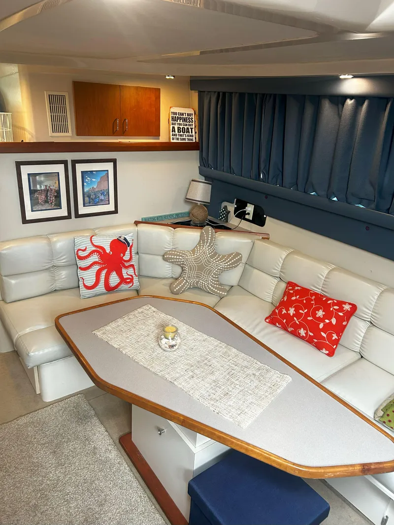 Slide: The Image of Interior of a 1997 Mainship 34' M/Y yacht with cozy seating and nautical decor. - 11