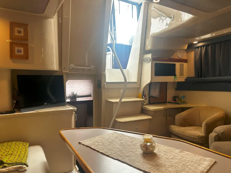 Slide: The Image of Interior of 1997 Mainship 34' M/Y yacht with cozy seating and modern amenities. - 12