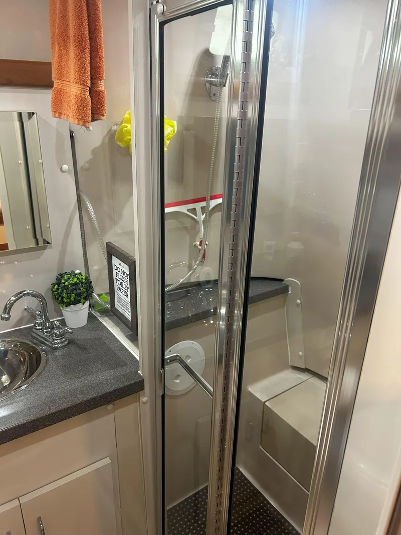 Slide: The Image of Bathroom interior of 1997 Mainship 34' M/Y yacht with shower and sink. - 20