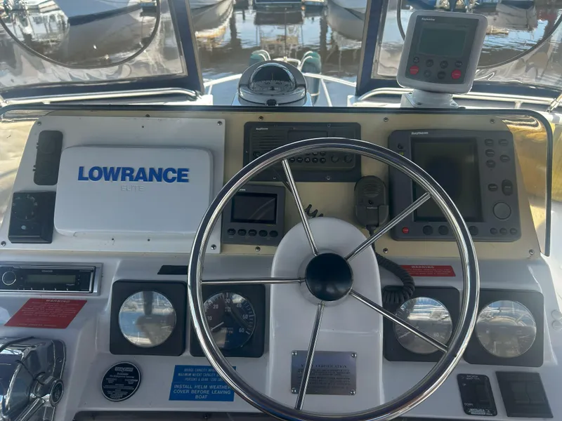 Slide: The Image of 1997 Mainship 34' M/Y helm with Lowrance electronics and navigation instruments. - 3