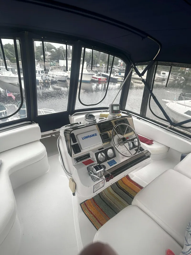 Slide: The Image of 1997 Mainship 34' M/Y yacht interior with helm, steering wheel, and navigation equipment. - 8