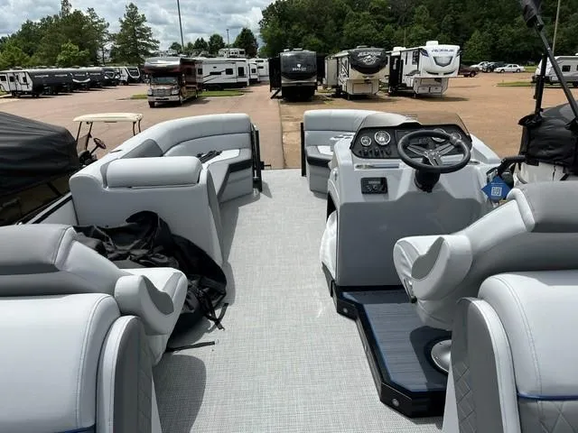 Slide: The Image of 2025 Veranda VS22RC pontoon boat interior with plush seating and modern dashboard. - 11