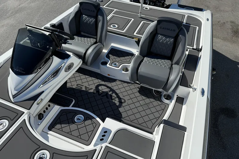 Slide: The Image of 2025 Caymas XS 21 boat interior with sleek seating and modern dashboard design. - 10
