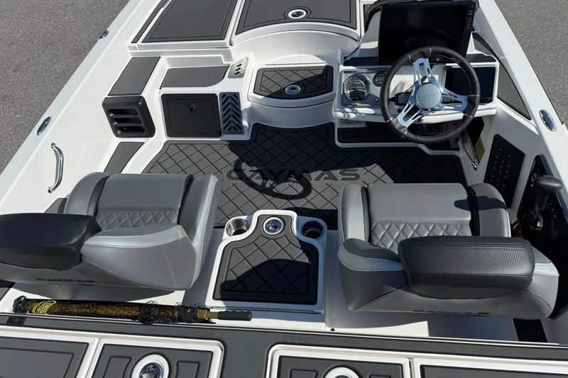 Slide: The Image of 2025 Caymas XS 21 boat interior with steering wheel, seats, and fishing rod. - 12