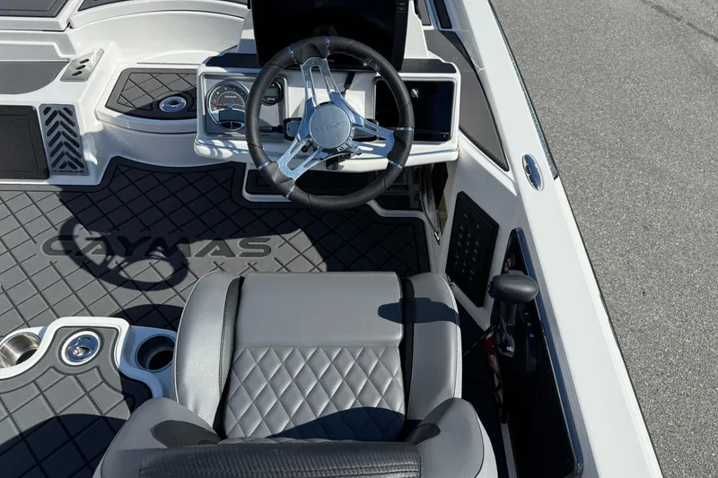 Slide: The Image of 2025 Caymas XS 21 boat interior with steering wheel and seating, featuring modern design. - 13