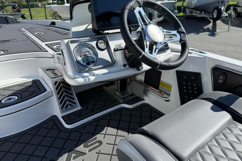 Slide: The Image of 2025 Caymas XS 21 boat interior with steering wheel and dashboard controls. - 14