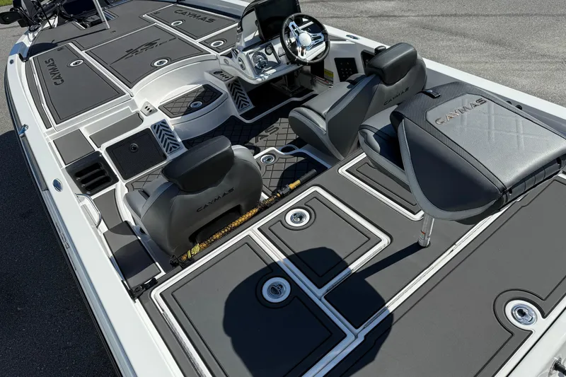 Slide: The Image of 2025 Caymas XS 21 boat interior with sleek seating and advanced dashboard design. - 15