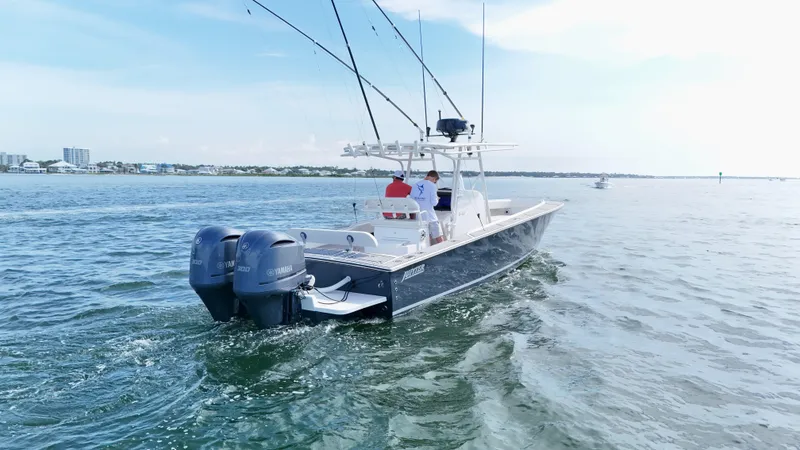 Slide: The Image of 2004 Jupiter 31 FS boat cruising on open water with dual engines. - 1