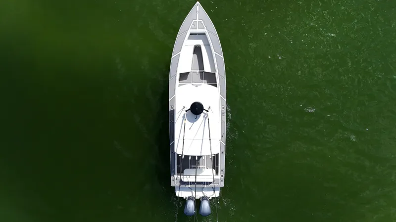 Slide: The Image of Overhead view of 2004 Jupiter 31 FS boat on green water. - 10