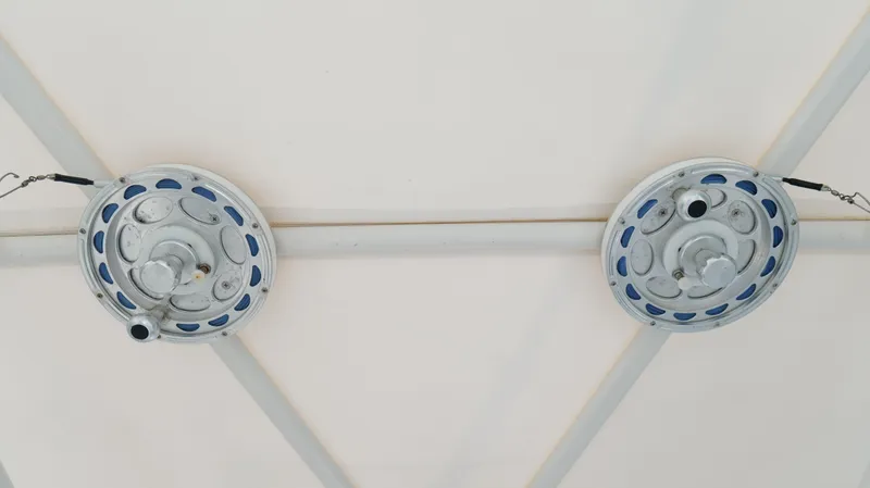 Slide: The Image of Two circular ceiling fixtures with metal chains on a white background. - 17