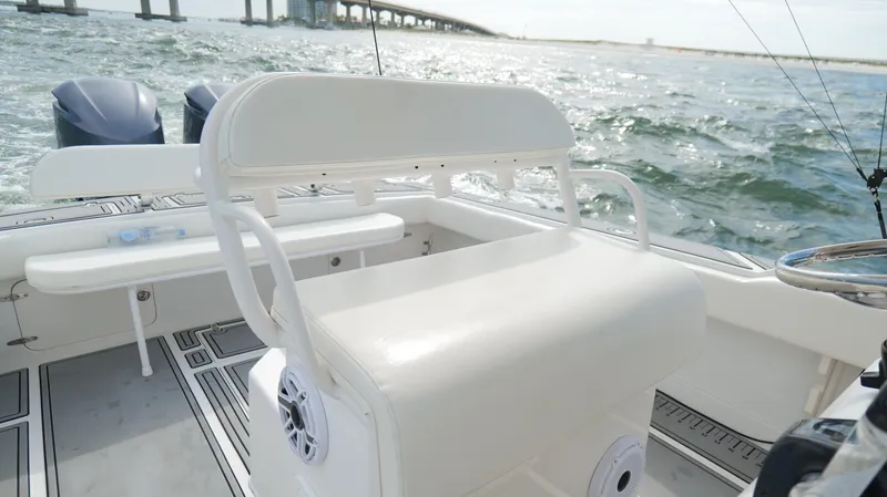 Slide: The Image of 2004 Jupiter 31 FS boat interior with seating, ocean view, and bridge in the background. - 18