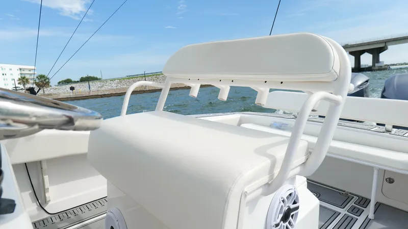 Slide: The Image of 2004 Jupiter 31 FS boat with white seating, on a sunny day near a bridge. - 19