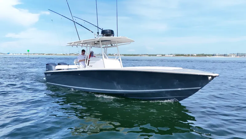 Slide: The Image of 2004 Jupiter 31 FS boat cruising on open water under a clear sky. - 2