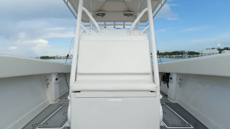 Slide: The Image of 2004 Jupiter 31 FS boat interior with white seating and open deck view. - 29