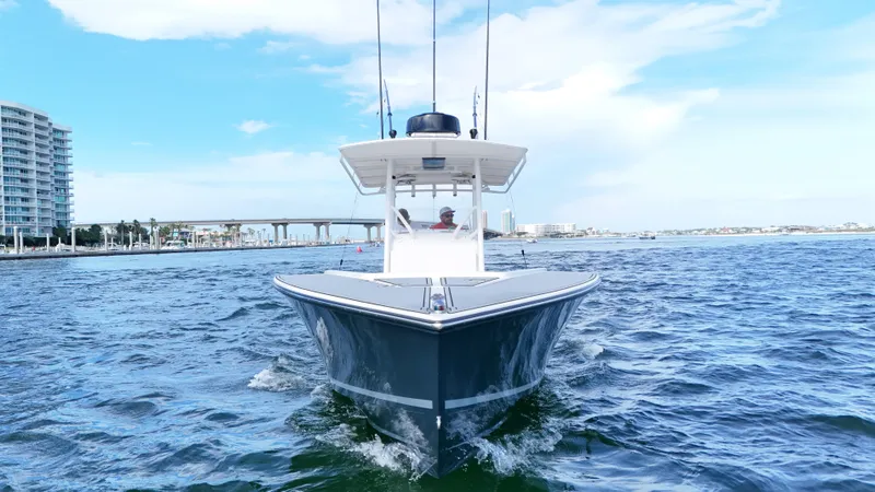 Slide: The Image of 2004 Jupiter 31 FS boat cruising on open water with cityscape background. - 3
