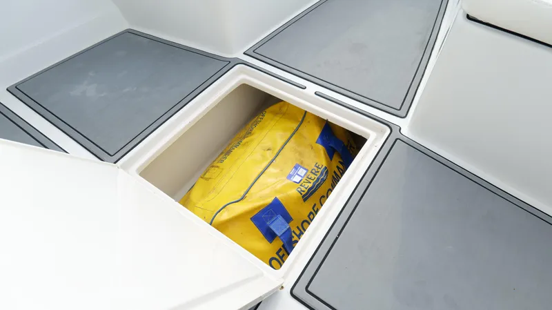 Slide: The Image of Storage compartment on a 2004 Jupiter 31 FS boat with a yellow bag inside. - 30