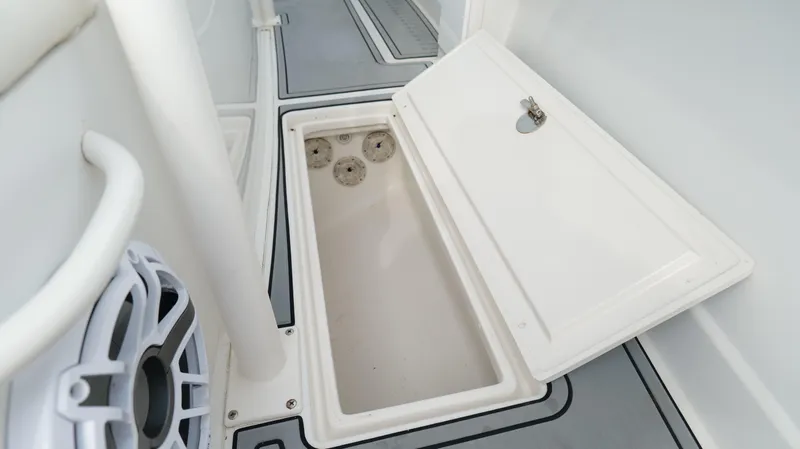 Slide: The Image of Open storage compartment on a 2004 Jupiter 31 FS boat deck. - 31