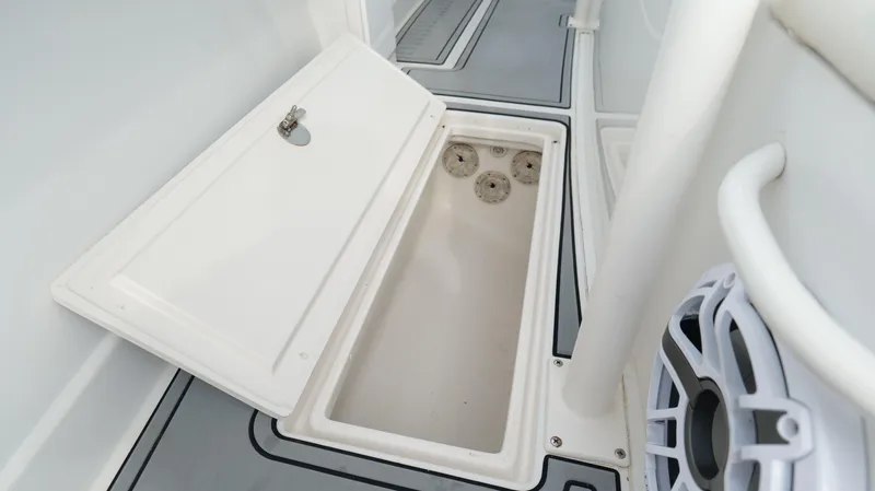Slide: The Image of Open storage compartment on a 2004 Jupiter 31 FS boat deck. - 32