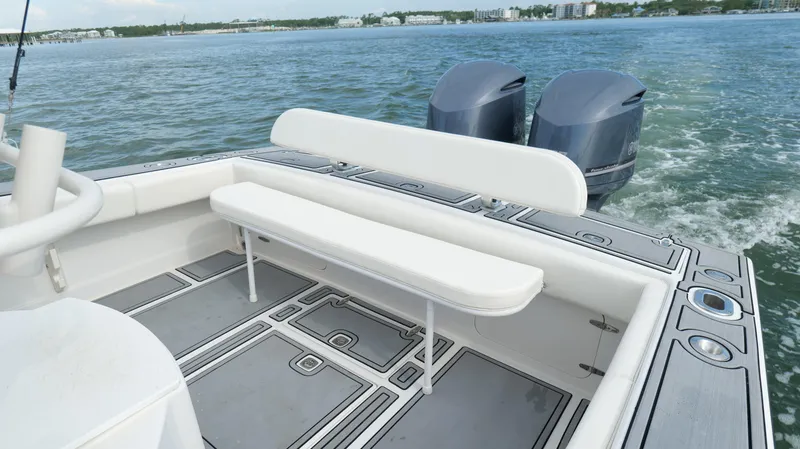 Slide: The Image of 2004 Jupiter 31 FS boat with dual engines and spacious seating on calm water. - 33