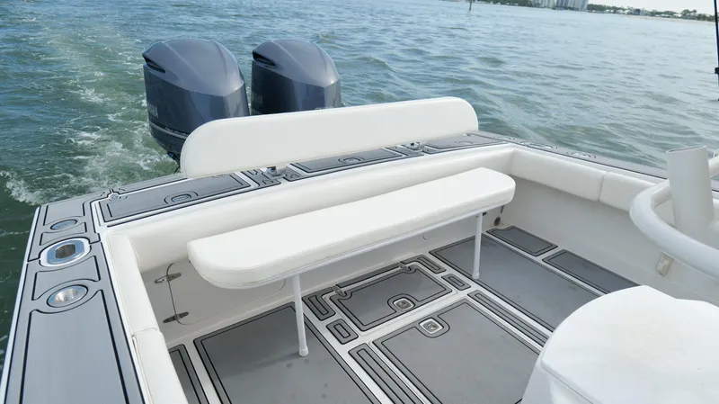 Slide: The Image of 2004 Jupiter 31 FS boat with dual engines and spacious seating on open water. - 34