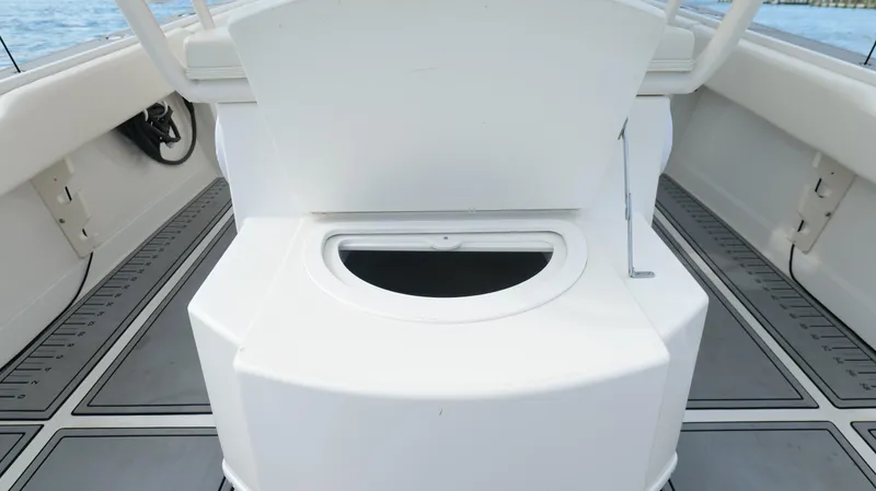 Slide: The Image of 2004 Jupiter 31 FS boat interior with open storage compartment on deck. - 37