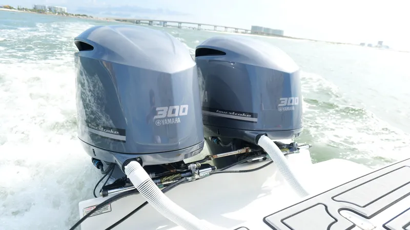 Slide: The Image of Twin Yamaha 300 outboard engines on a 2004 Jupiter 31 FS boat in motion. - 38