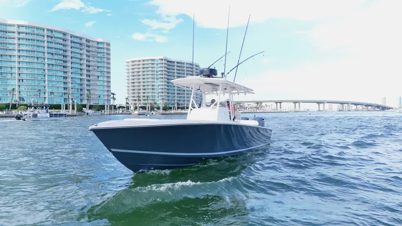 Slide: The Image of 2004 Jupiter 31 FS boat cruising near waterfront buildings and bridge. - 4