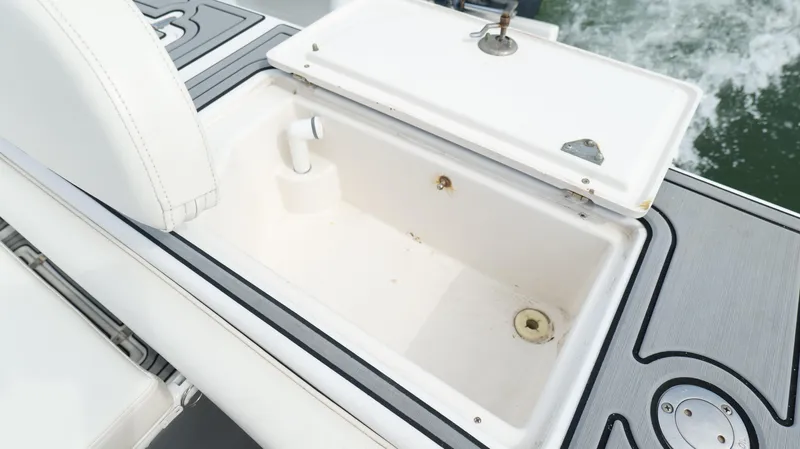 Slide: The Image of Open storage compartment on 2004 Jupiter 31 FS boat, featuring white interior and sleek design. - 41