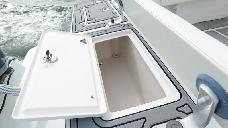 Slide: The Image of Open storage compartment on 2004 Jupiter 31 FS boat, with ocean in background. - 42