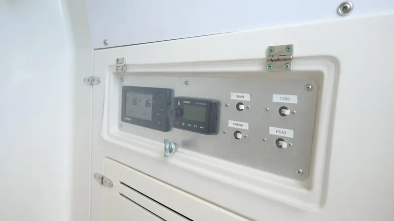 Slide: The Image of Control panel of a 2004 Jupiter 31 FS boat, featuring navigation and system switches. - 46