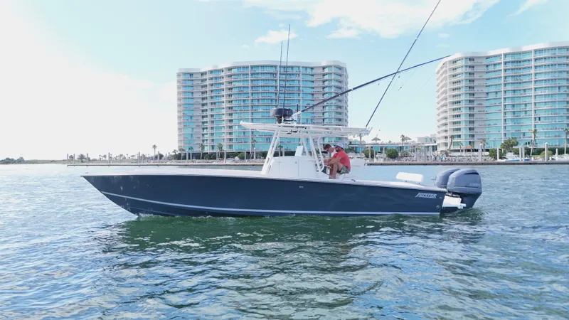 Slide: The Image of 2004 Jupiter 31 FS boat on water with modern buildings in the background. - 5