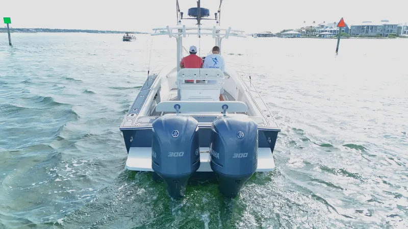 Slide: The Image of 2004 Jupiter 31 FS boat with dual 300 horsepower engines on open water. - 7