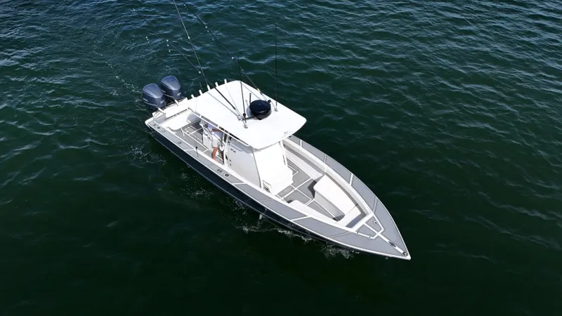 Slide: The Image of 2004 Jupiter 31 FS boat cruising on open water, aerial view. - 8