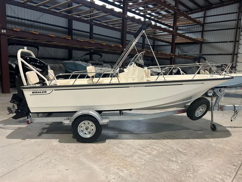 The Image of 2026 Boston Whaler 170 Montauk boat on trailer in indoor storage facility. - 1