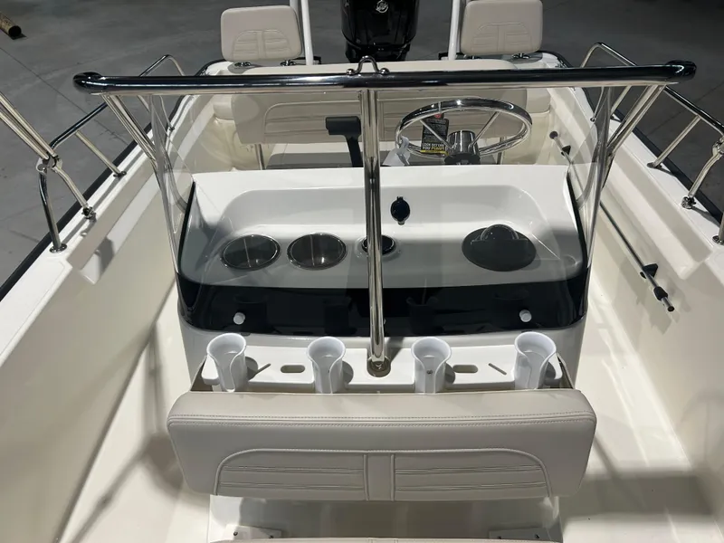 Slide: The Image of 2026 Boston Whaler 170 Montauk boat interior with steering console and cup holders. - 12
