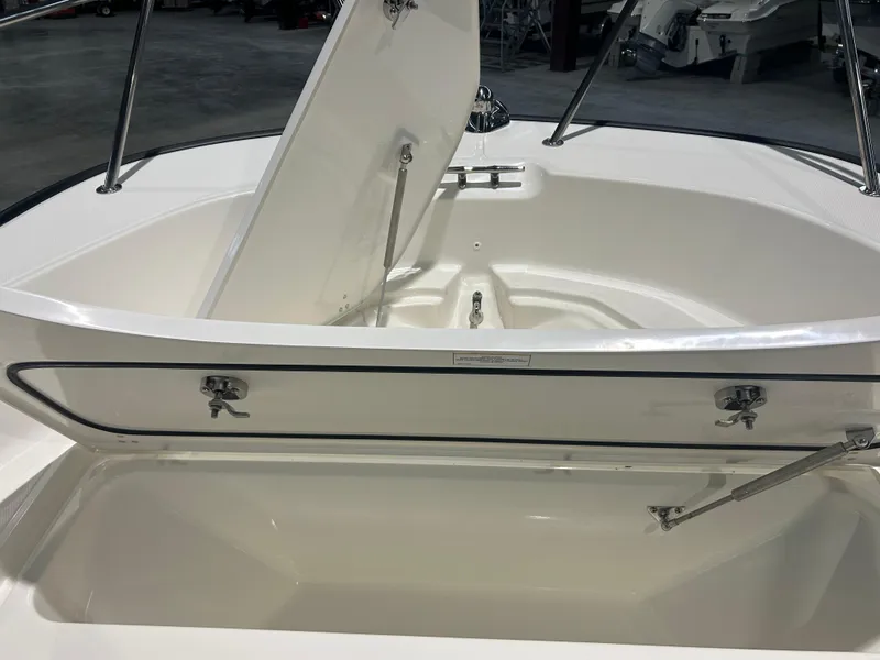 Slide: The Image of 2026 Boston Whaler 170 Montauk boat storage compartment open, showcasing interior design. - 13