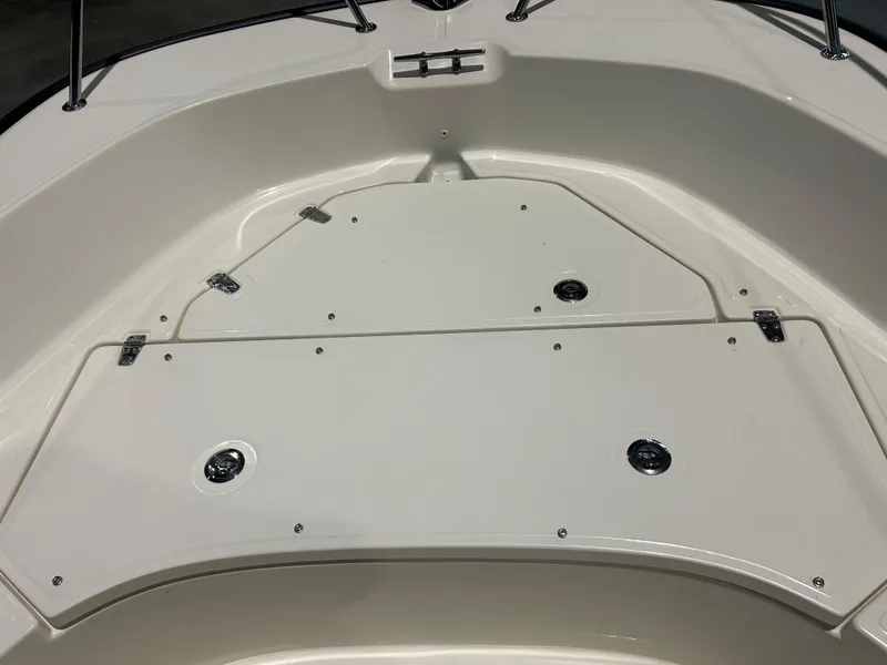 Slide: The Image of 2026 Boston Whaler 170 Montauk bow storage compartment with secure latches. - 14