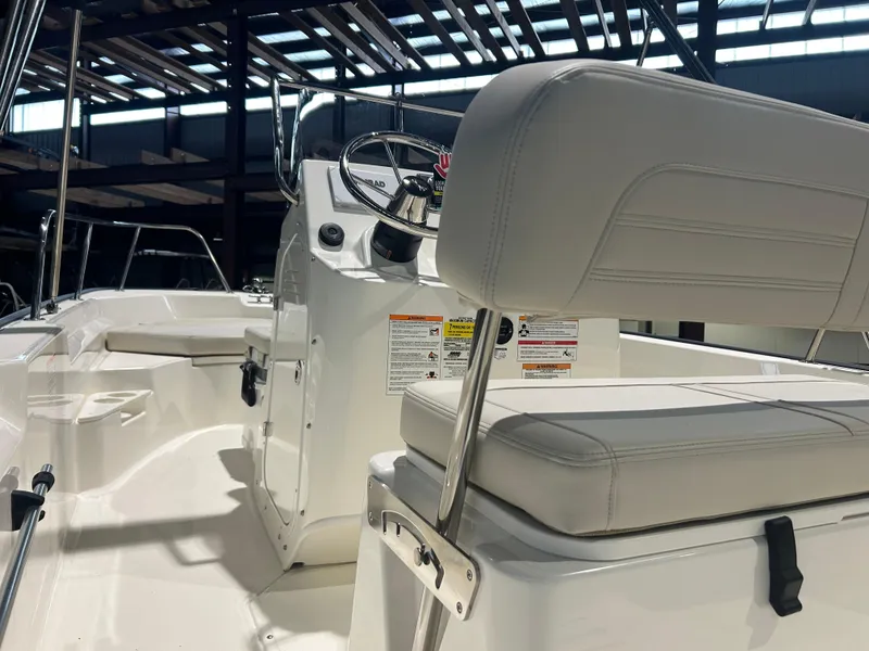 Slide: The Image of 2026 Boston Whaler 170 Montauk interior with steering console and seating. - 17