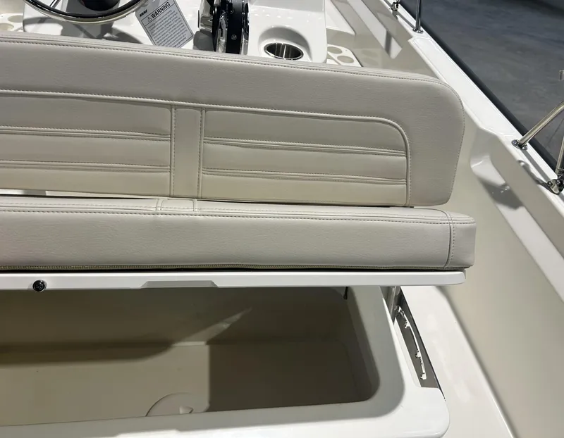 Slide: The Image of 2026 Boston Whaler 170 Montauk boat seat with storage compartment open. - 18