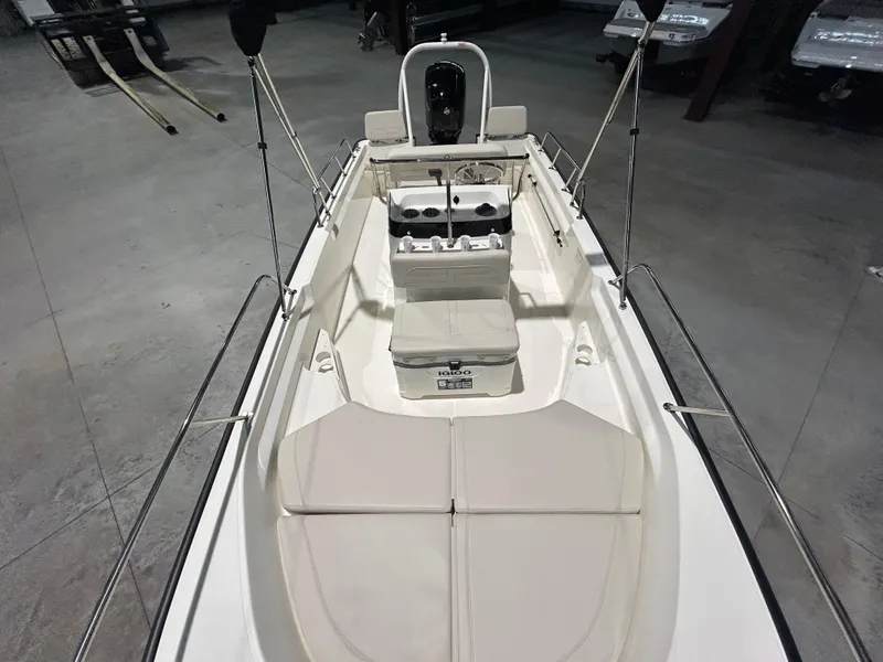 Slide: The Image of 2026 Boston Whaler 170 Montauk boat interior with seating and console, in a showroom setting. - 24