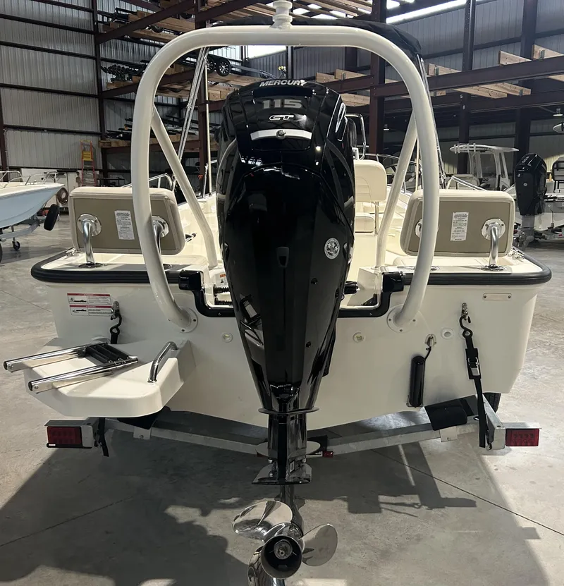 Slide: The Image of 2026 Boston Whaler 170 Montauk boat with Mercury engine in a warehouse. - 6