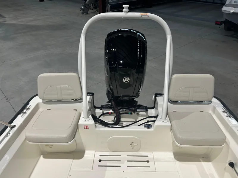 Slide: The Image of 2026 Boston Whaler 170 Montauk boat interior with motor and seating. - 7