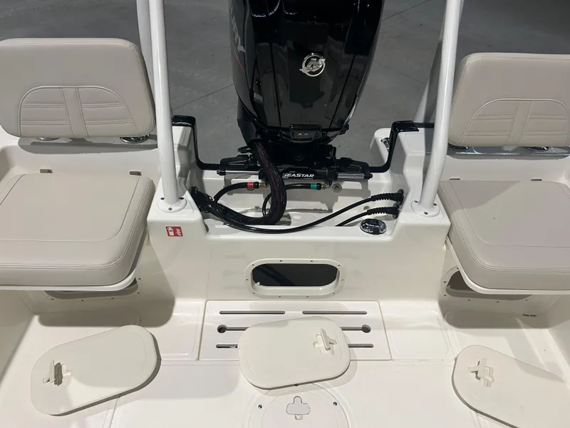 Slide: The Image of 2026 Boston Whaler 170 Montauk boat interior with seating and engine view. - 8