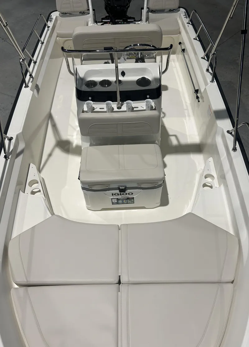 Slide: The Image of 2026 Boston Whaler 170 Montauk interior with seating and console, featuring Igloo cooler. - 9