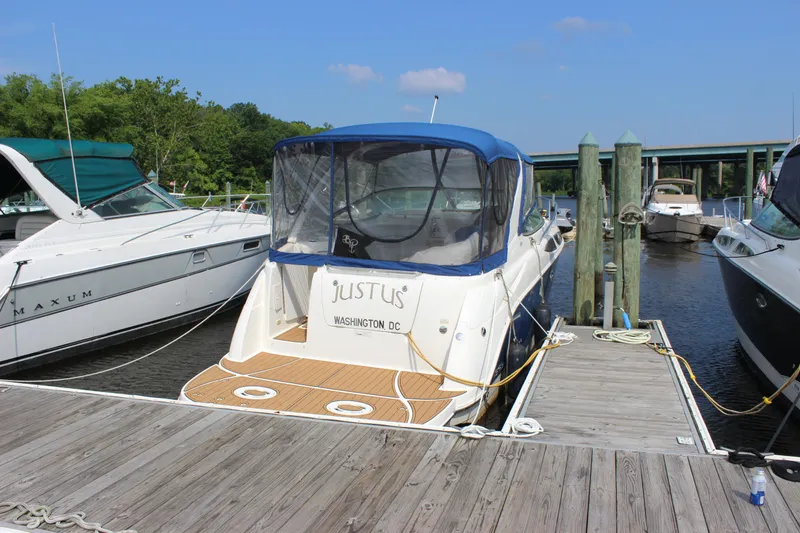 The Image of 2012 Bayliner 315 Cruiser docked at marina, blue canopy, Washington DC registration. - 1