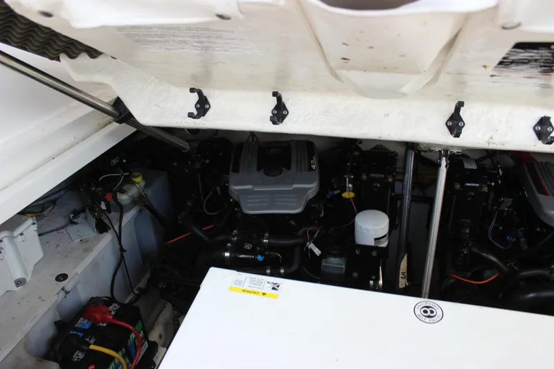 Slide: The Image of Engine compartment of a 2012 Bayliner 315 Cruiser, showcasing mechanical components and wiring. - 10