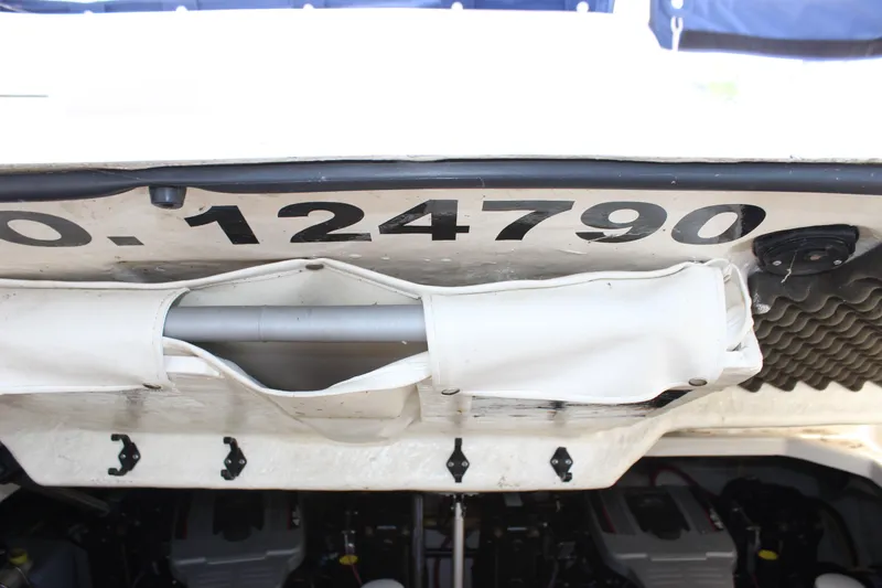 Slide: The Image of 2012 Bayliner 315 Cruiser boat registration number and storage compartment. - 11