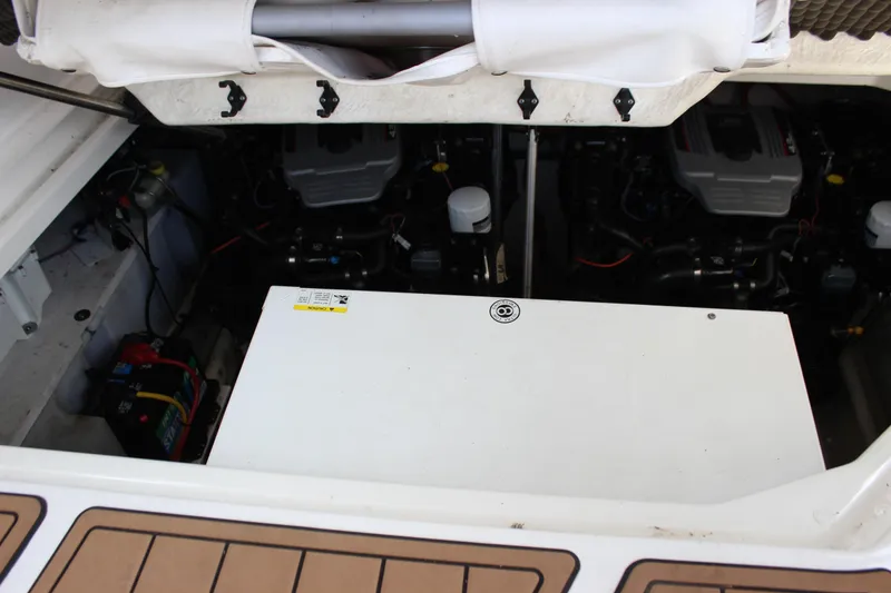 Slide: The Image of Engine compartment of a 2012 Bayliner 315 Cruiser, showcasing dual engines and battery setup. - 13