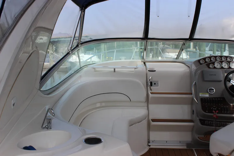 Slide: The Image of 2012 Bayliner 315 Cruiser cockpit with steering wheel, dashboard, and seating area. - 4