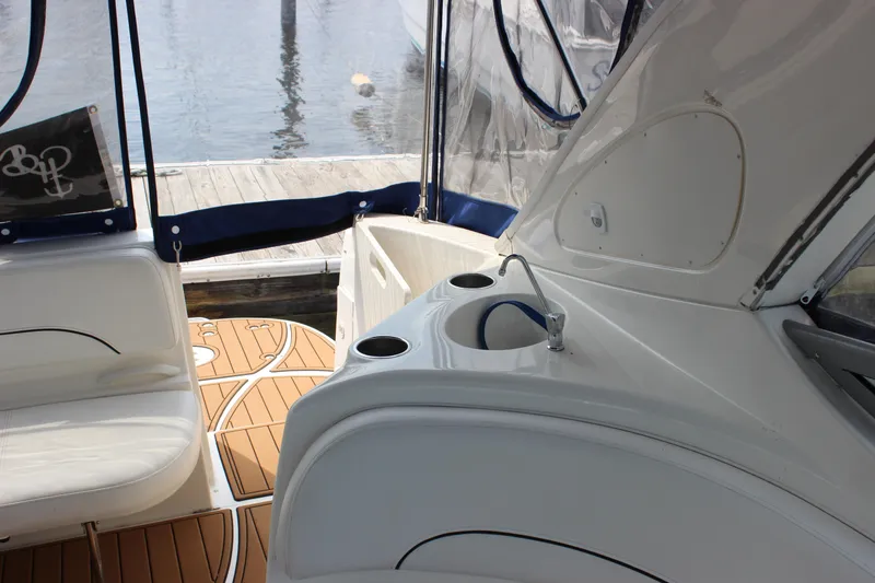 Slide: The Image of 2012 Bayliner 315 Cruiser interior with sink, seating, and wood-patterned flooring. - 7